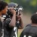 A Ypsilanti Community High School football player smiles while on the sidelines during practice at the school on Monday, August 12, 2013. Melanie Maxwell | AnnArbor.com